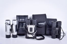 Three pairs of modern compact binoculars.
