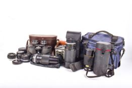 A group of vintage cameras lenses with a pair of 8x40 Hilkinson binoculars in a case.