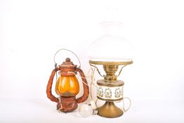 Two converted oil lamps. Including a brass example with white shade and a chimney, etc.