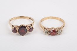 Two 9ct gold and garnet three-stone rings.
