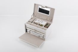 A small group of costume jewellery in a white jewellery box.