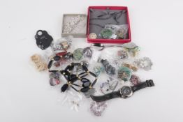 A collection of costume jewellery and fashion watches.