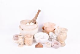 A group of stone carved items. Including pestle and mortars, etc.
