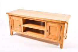 A modern light oak tv entertainment cabinet stand.