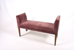 Contemporary upholstered bench seat on stained beech tapering legs.