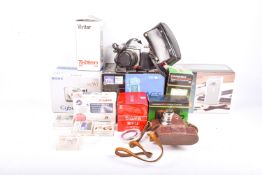 A collection of assorted vintage film and digital cameras and accessories.