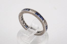 A white metal, blue and white stone eternity ring.