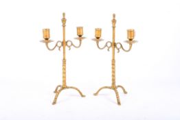 A pair of early 19th century brass twin-arm rise and fall candlesticks. H30cm.