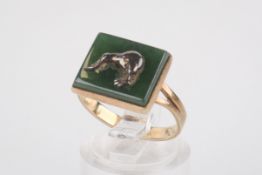 A yellow metal panel ring. Rectangular head of nephrite with applied white metal kiwi bird motif.