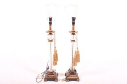 Pair of reproduction glass column and patinated plinth table lamps.