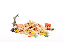 A Brio wooden toy train set and accessories. Including lengths of track, a crane, garage, etc.
