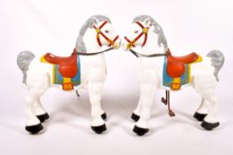 Two cast metal Mobo ride on horses.