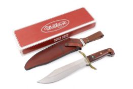 A Western Bowie Knife with a leather scabbard, boxed. Total length 37cm.