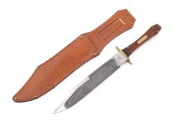 A modern collector's Bowie style knife engraved 'Winchester' with a scabbard. Total length cm.