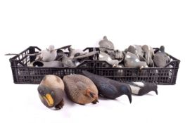 Three boxes of duck and pigeon decoys.