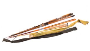 A collection of vintage sea fishing beach casters and boat rods.