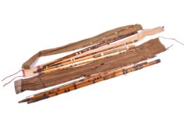 Three vintage bamboo fishing rods.