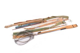 A collection of assorted fishing rods and landing nets.