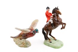 Two Beswick ceramic figures modelled as a huntsman and a pheasant.