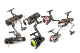 Seven assorted fixed spool fishing reels. Makers include Okuma, Daiwa and Shimano.