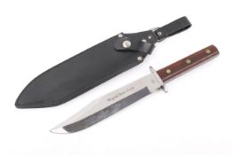 An 'Origina Bowie Knife' in a black leather scabbard. Total length 34cm.