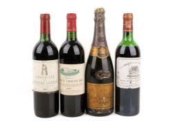 Three bottles of assorted red wine and a bottle of 1980 Veuve Clicquot Ponsardin.