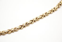 An Italian 9ct gold cross-link necklace. Hallmarked to clasp, width 6mm, length 42cm, weight 22.6g.
