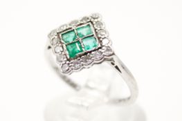 A platinum (tested) panel ring set with four square cut emeralds of 0.