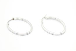 A pair of 9ct white gold hoop earrings.