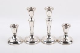 Two pairs of Stirling silver hallmarked weighted candlesticks. Birmingham, 1995 and 1993, by LJM.