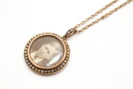 A late Victorian/Edwardian open picture pendant and chain. The pendant of circular form, 2.
