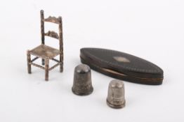 Three small white metal novelty items and an oval Georgian 'patch' box.