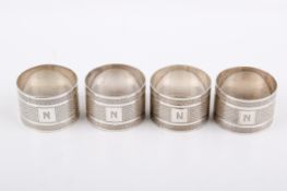 A set of four Stirling silver hallmarked napkin rings. Sheffield, 1933, 'E.V'.
