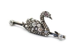An antique yellow and white metal bar brooch with diamond set swan motif.