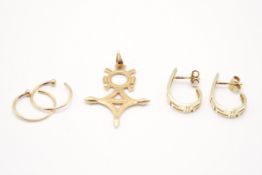 A gold pendant and two pairs of earrings.