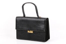A vintage black lizard skin handbag.