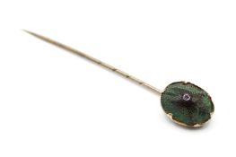 A vintage gold plated tie pin mounted with a scarab beetle.