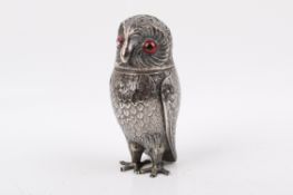 A Victorian Stirling silver hallmarked novelty pepper pot modelled as an owl. With red glass eyes.