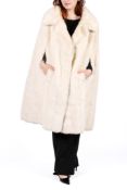 An 'Astraka' white faux mink cape.