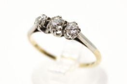 An 18ct gold three stone diamond ring. The largest stone circa 3.