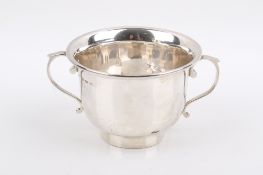 A Stirling silver hallmarked twin-handled footed cup. Having scroll handles by S.
