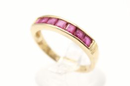 A gold and ruby band ring.