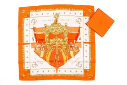A Hermes La Reale orange, white and gold silk scarf. Boxed with tag.