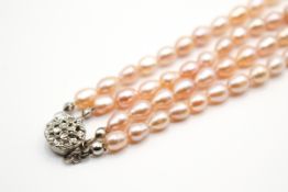 A double strand of pale pink freshwater pearls.