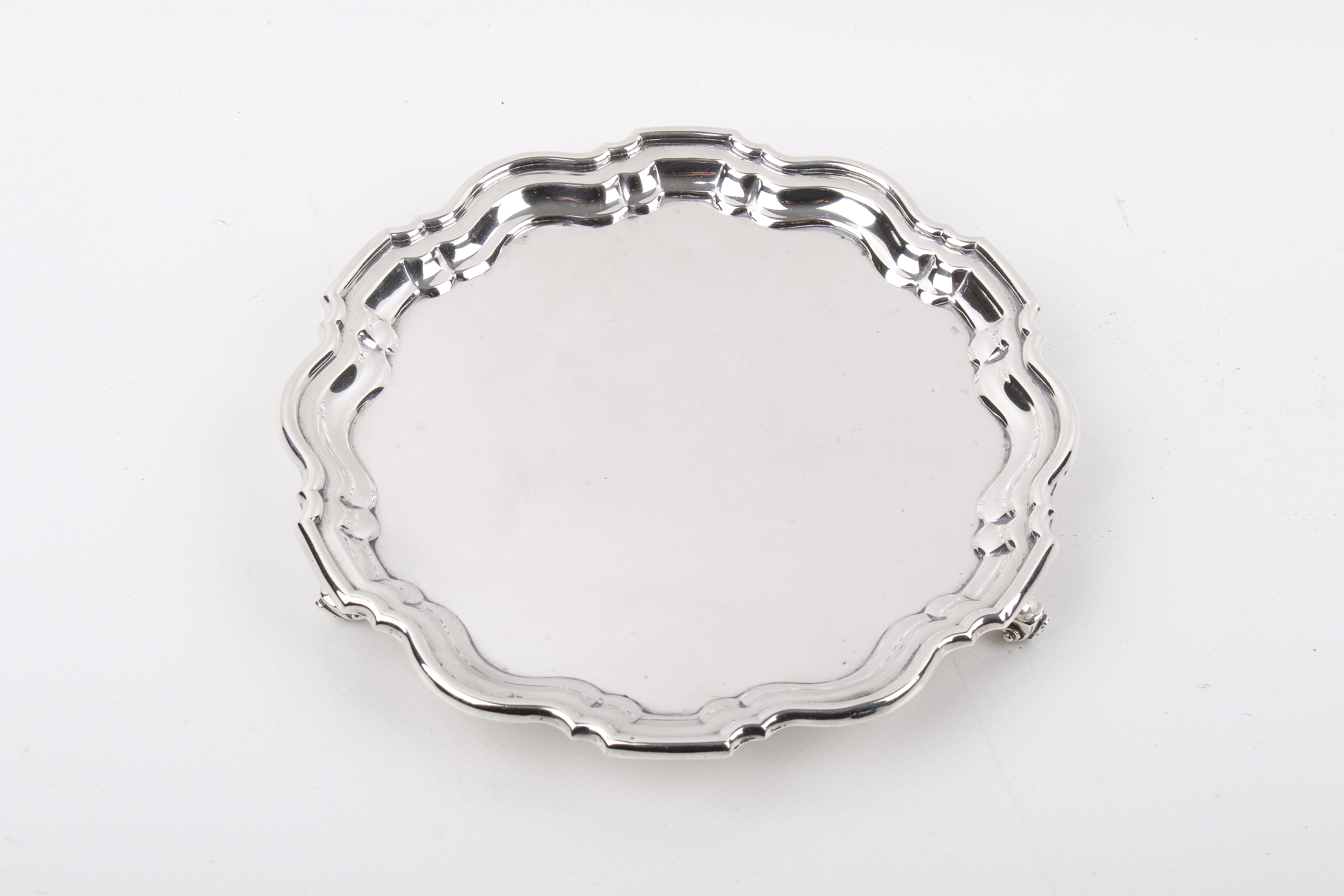A Stirling silver hallmarked waiter with pie crust rim.