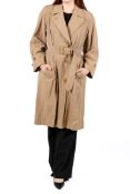 A lady's Burberry's trench coat constructed from a light brown cotton/polyester mix with a length