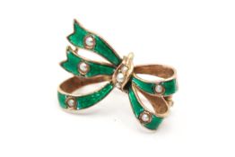 A 9ct goldand green enamelled bow brooch with seed pearl detail. Tested 9ct gold. W2.5cm, 2.