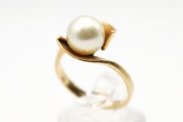 A yellow metal dress ring set with one cultured akoya pearl of 8.1mm diameter.