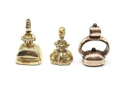 Three 19th century yellow metal fob seals. Each with carved stone intaglio.