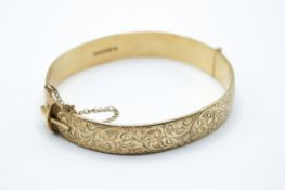 A 9ct gold hinged bangle.
